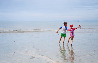 kids in Santa hat on the beach