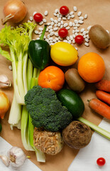 Raw fresh vegetables for healthy cooking. Celery, beans, carrots, avocado, lemon, broccoli are a vegan paradise.