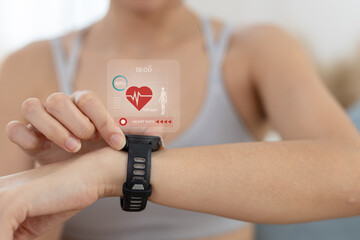 Women Point to smartwatch displaying heart rate application. Monitoring virtual display measure heart rate before after physical exercise. wristwatch checking heart beats and pulse.