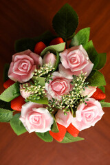 Handmade soap bouquet a dark key. Composition of artificial plants and branches and buds of flowers and berries from soap.