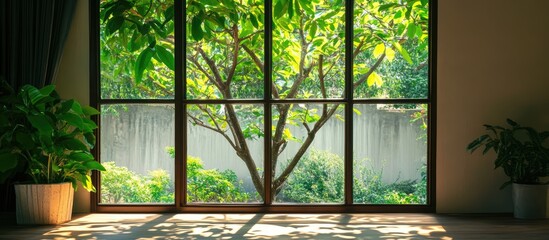 Serene indoor view through large window showcasing vibrant greenery and natural light enhancing...