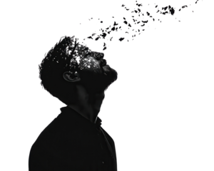Silhouette of a man releasing colorful particles against a black background.