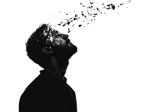 Silhouette of a man releasing colorful particles against a black background.