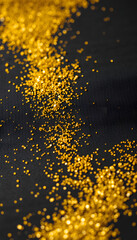 Fototapeta premium Gold glitters on black felt, professional photography. isolated with white highlights
