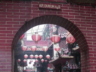 The entrance to a traditional Chinese temple, framed by a weathered brick arch