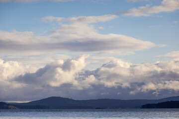 Scenic View of Clouds and Hills Over a Tranquil Ocean Landscape