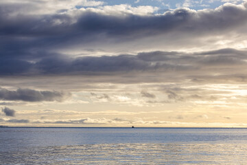 Serene Ocean View at Sunset Under Dreamy Cloudy Sky