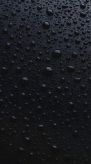 Water droplets on a dark textured surface