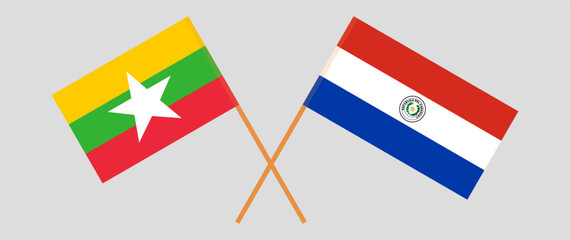 Crossed flags of Myanmar and Republic of Paraguay. Official colors. Correct proportion. Vector illustration