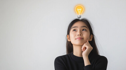 Business concept. Light bulb sign icon above Asian businesswoman's head. An employee who comes up with a new idea for his job. Asian woman coming up with a new idea during brainstorming