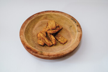Delicious fried tempeh or fried tempeh is ready to eat, with a white background.