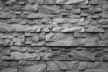 The photo shows decorative facing tiles in the form of grey bricks