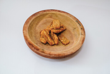 Delicious fried tempeh or fried tempeh is ready to eat, with a white background.