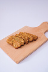 Delicious fried tempeh or fried tempeh is ready to eat, with a white background.