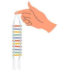 Hand holds a ladder for birds. Accessories for a parrot cage