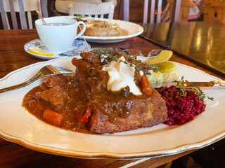 Potato cake with beef goulash.