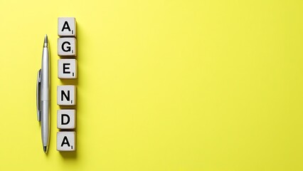 Agenda word on yellow background with copy space for text.