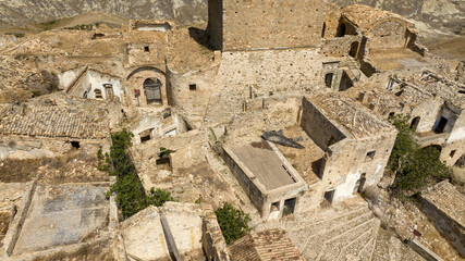 Aerial view on the historic center of Craco, a ghost town in province of Matera, Basilicata, Italy. The historic center was depopulated due to a landslide and has become a tourist destination.
