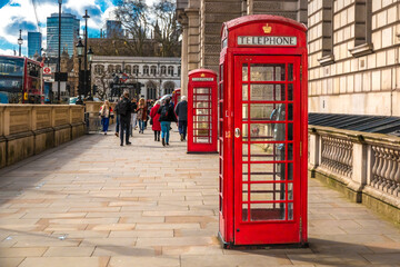 Great image of two iconic red K6 telephone boxes in Parliament Street towards Westminster Abbey in London, England. The traditional British phone kiosk is a popular tourist attraction. 