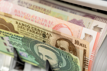 Paraguay money. Paraguay banknotes counted by money counter. Financial concept
