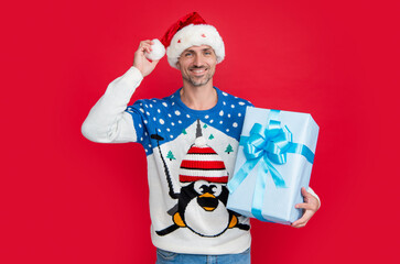 gift for christmas. cheerful caucasian man hold christmas gift isolated on red. man with gift