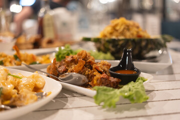 Soft shell crab fried with garlic and many seafood on table