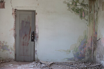 Abandoned factory in decay with crumbling walls and broken windows. Industrial ruins showing urban...