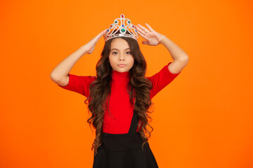 Selfish girl is a party princess. Happy birthday. Birthday girl isolated on orange. Teen girl in...
