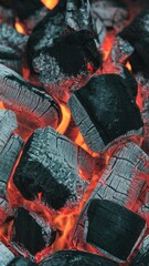 Burning charcoal in barbecue pit with red embers glowing
