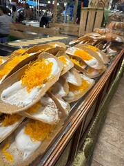 A large assortment of food items stacked together precariously on a table