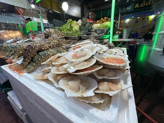 A seafood tray on a table in a busy restaurant attracts diners