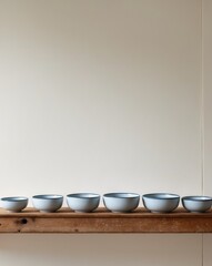 A row of blue and white bowls sitting on top of a wooden shelf