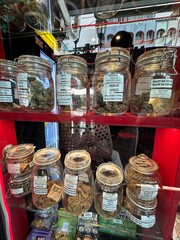 A shelf that is filled with numerous jars containing various foods