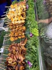 A variety of delicious skewers of food are sitting on a table