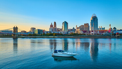 Fototapeta premium Cincinnati Skyline at Golden Hour with Riverboat Aerial