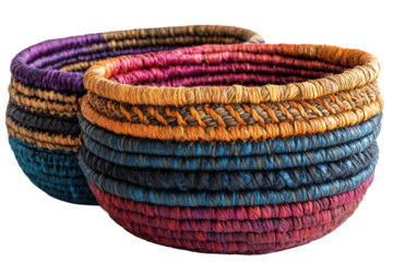 Colorful woven baskets stacked together, showcasing intricate patterns and textures against a white isolated background.