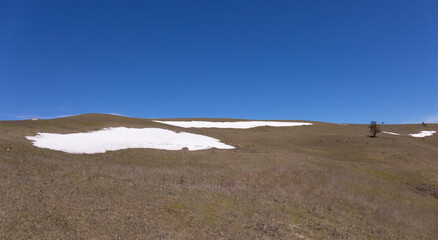 In some places there is snow in the mountains.
