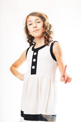 Serious young girl raising index finger in warning gesture