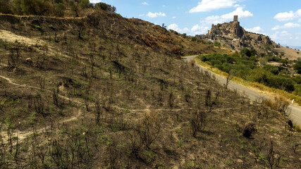 View of Craco, a ghost town in the province of Matera, Basilicata, Italy. The historic center was depopulated due to a landslide and has become a tourist destination.