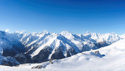 Obraz premium A panoramic view of majestic snow-covered peaks stretching across the horizon under a clear blue sky, with crisp, vivid details capturing the serene alpine landscape.