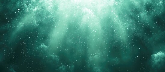 Teal underwater scene with light beams and particles.