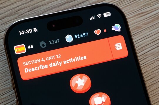 Duolingo language learning mobile app on iOS smartphone, Spanish course with dark theme