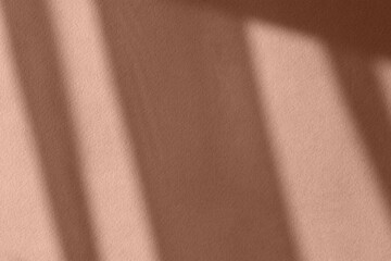 Shadows on the wall. A demonstration of the mocha mousse color. The trending fashionable color of...