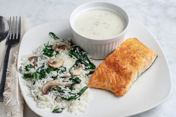 seasoned salmon  served with rice , spinach and mushrooms