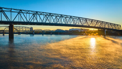 Aerial of Steel Bridge at Sunrise Over Misty Ohio River