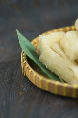 Close-Up of Cassava in Basket on Rustic Wooden Surface