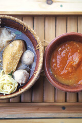 Malang Meatballs Served in a Rustic Bowl With Spicy Sauce In Rustic Setting