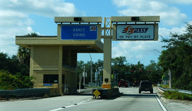 Orlando, Florida, U.S.A - Nov 14, 2024 - The toll plaza with clear signage for exact coins, E-Pass or pay by plate
