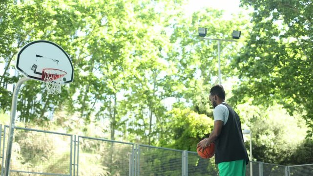 Basketball player shooting free throw on outdoor court