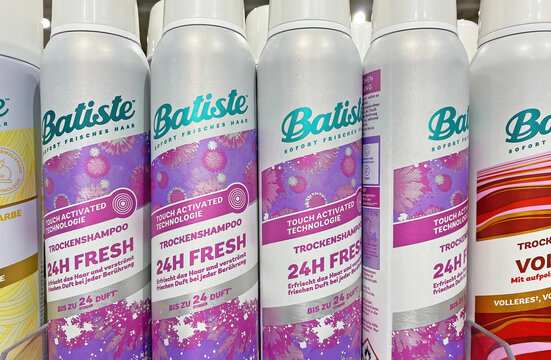 Viersen, Germany - December 8. 2024: Closeup of cans Batiste dry shampoo in german store (focus on central cans)